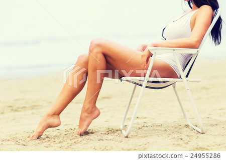 close up of woman sunbathing in lounge on beach close up of woman sunbathing in lounge on beach 24955286