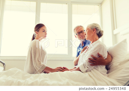 family visiting ill senior woman at hospital family visiting ill senior woman at hospital 24955348