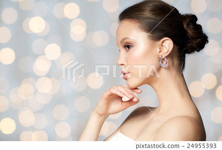 close up of beautiful woman face with earring close up of beautiful woman face with earring 24955393