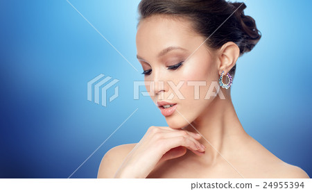 close up of beautiful woman face with earring close up of beautiful woman face with earring 24955394