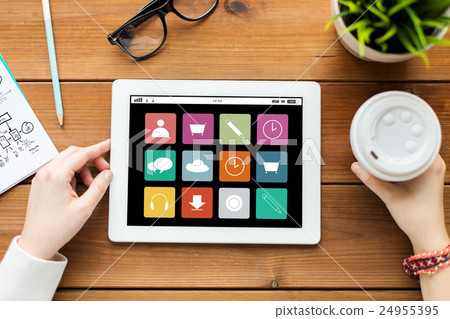 close up of woman with tablet pc on wooden table close up of woman with tablet pc on wooden table 24955395