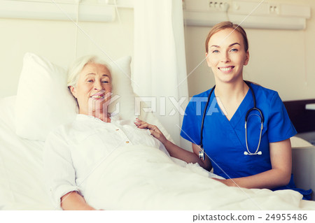 doctor or nurse visiting senior woman at hospital 24955486