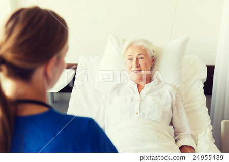 doctor or nurse visiting senior woman at hospital 24955489