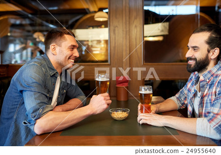 happy male friends drinking beer at bar or pub happy male friends drinking beer at bar or pub 24955640