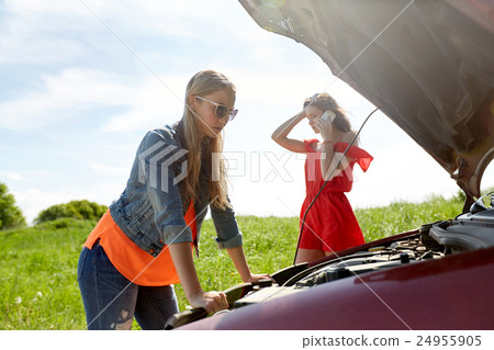 women with open hood of broken car at countryside women with open hood of broken car at countryside 24955905