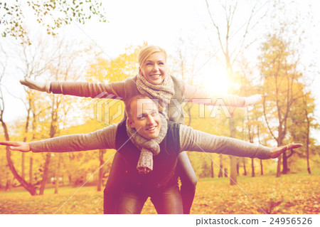 smiling couple having fun in autumn park smiling couple having fun in autumn park 24956526