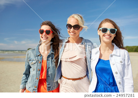 group of smiling women in sunglasses on beach group of smiling women in sunglasses on beach 24957281