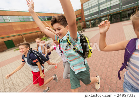 group of happy elementary school students running 24957332
