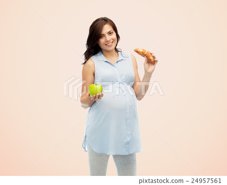 happy pregnant woman with apple and croissant happy pregnant woman with apple and croissant 24957561