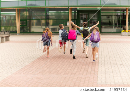 group of happy elementary school students running group of happy elementary school students running 24957584