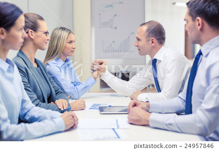 businesswoman and businessman arm wrestling 24957846