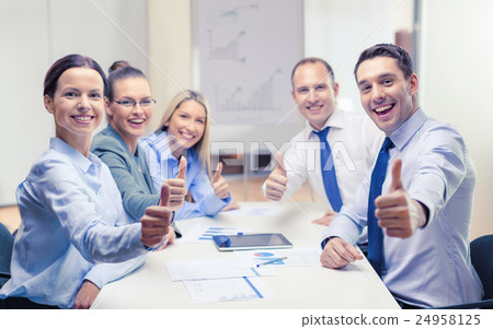 business team showing thumbs up in office 24958125