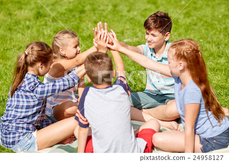 group of happy kids making high five outdoors group of happy kids making high five outdoors 24958127