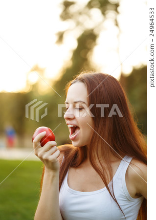 Girl eating an apple Girl eating an apple 24964533