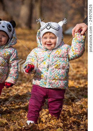 The two little baby girls standing in autumn The two little baby girls standing in autumn 24970626