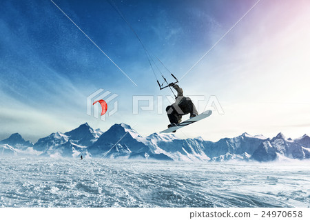 Young men, ride snowboarding on frozen lake 24970658