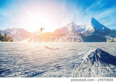 Young men, skiing on frozen lake in the mountains 24970666
