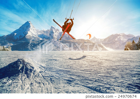 Young men, skiing on frozen lake in the mountains 24970674