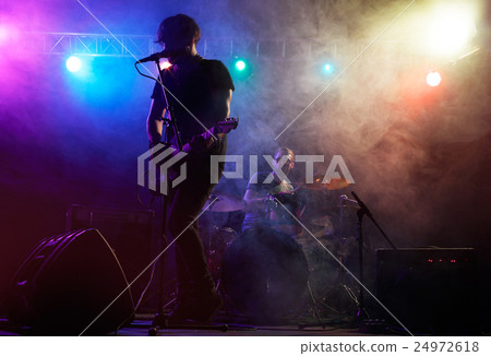 Silhouette of guitar player on stage. 24972618
