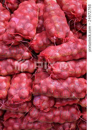 Sacs containing Large onion stacked for sale Sacs containing Large onion stacked for sale 24972768