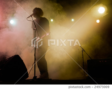 Silhouette of guitar player on stage. Silhouette of guitar player on stage. 24973009
