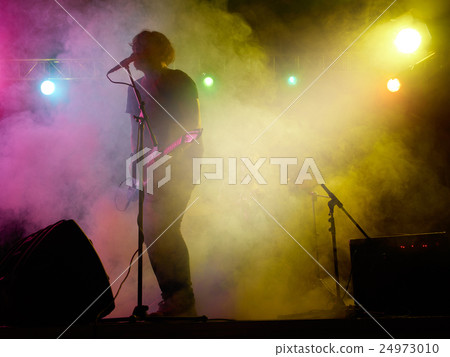 Silhouette of guitar player on stage. Silhouette of guitar player on stage. 24973010