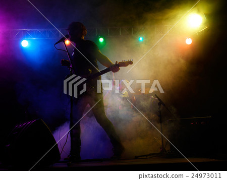 Silhouette of guitar player on stage. Silhouette of guitar player on stage. 24973011