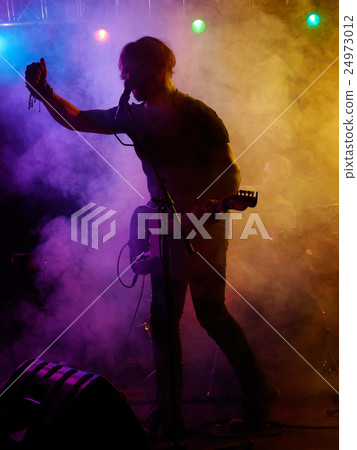Silhouette of guitar player on stage. Silhouette of guitar player on stage. 24973012