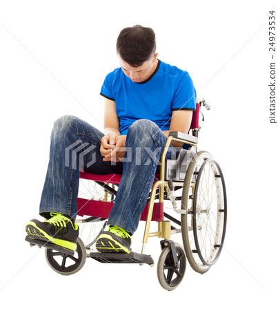 frustrated handicapped man sitting on a wheelchair frustrated handicapped man sitting on a wheelchair 24973534