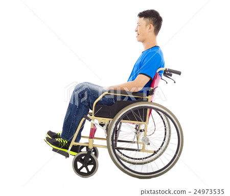 hopeful young man sitting on  wheelchair in studio 24973535
