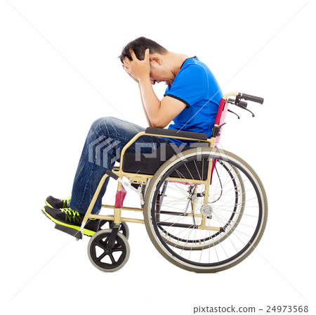 upset  and handicapped man sitting on a wheelchair 24973568
