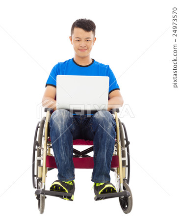 young man sitting on a wheelchair with a laptop 24973570