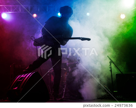 Silhouette of guitar player on stage. 24973636