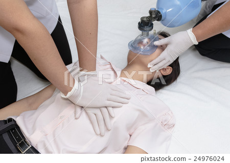 Medical team is giving first aid to young woman 24976024