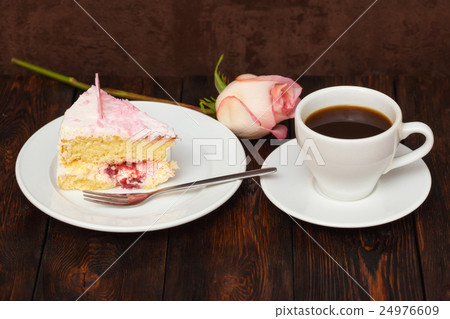 Cake slice and coffee cup with rose on wooden 24976609