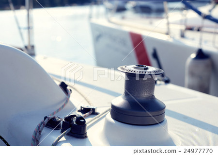 Grey winch on the white yacht without hawser 24977770
