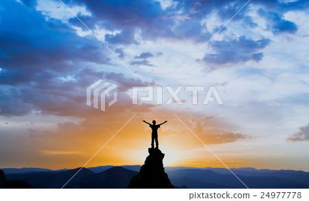 man on the top of a rock 24977778