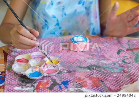 Little hands of kid painting on the plaster. Little hands of kid painting on the plaster. 24984048