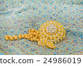 Golden jewelry on  elegance fabric 24986019