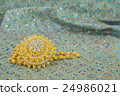 Golden jewelry on  elegance fabric 24986021