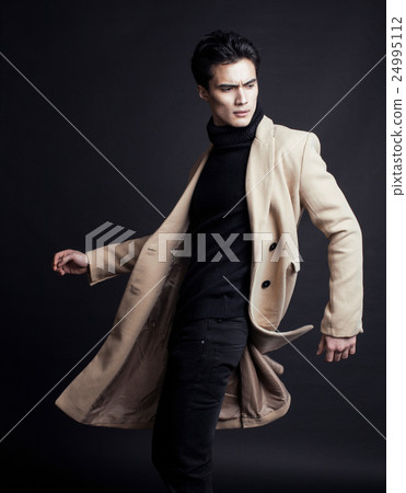 cool real young man in coat on black background cool real young man in coat on black background 24995112