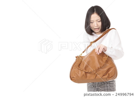 A young woman looking for something left behind 24996794