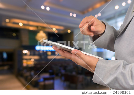 Businessman Use Wireless Tablet Device Businessman Use Wireless Tablet Device 24998301