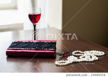 Book, glass of wine, beads Book, glass of wine, beads 24999358