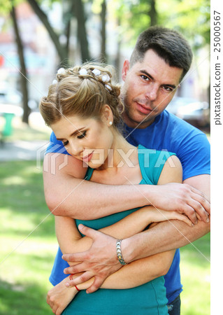 In love guy holding girl in his arms. 25000567