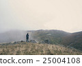 Woman hiking on a cloudy autumn day 25004108