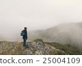 Woman hiking on a cloudy autumn day 25004109