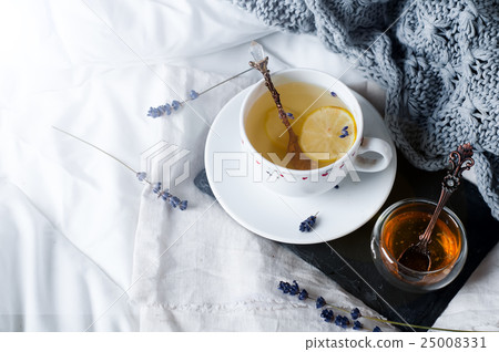 tray with honey and a cup of hot tea in the bed tray with honey and a cup of hot tea in the bed 25008331