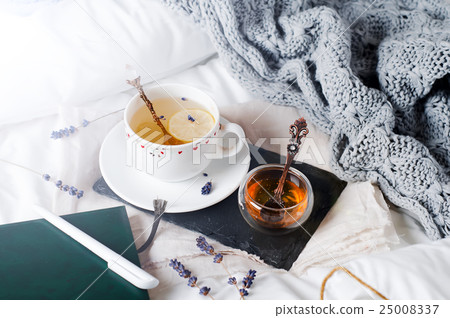 tray with honey and a cup of hot tea in the bed tray with honey and a cup of hot tea in the bed 25008337
