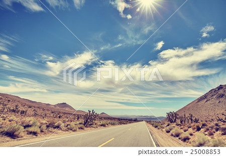 Vintage toned desert road against sun. Vintage toned desert road against sun. 25008853